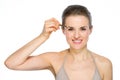 Beauty portrait of woman applying brown eye liner