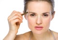Beauty portrait of woman applying brown eye liner