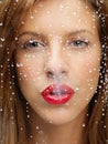 Beauty portrait of woman behind wet window Royalty Free Stock Photo