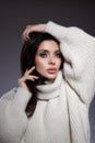 Beauty portrait of woman in white sweater, perfect evening makeup on dark background. Perfect skin without wrinkles, professional Royalty Free Stock Photo