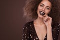 Beauty portrait of young african american girl with afro hairstyle and chocolate . Girl posing on brown background Royalty Free Stock Photo