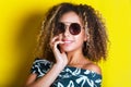 Beauty portrait of young african american girl with afro hairstyle. Girl posing on yellow background, looking at camera. Studio sh Royalty Free Stock Photo