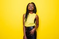 Beauty portrait of young african american girl posing on yellow background, looking at camera, smiling. Royalty Free Stock Photo