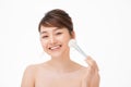 Beauty portrait young asian woman smile with brush cheek skin care and cosmetic concept