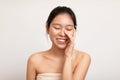 Beauty portrait of young Asian woman touching her clean face Royalty Free Stock Photo
