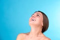 Beauty portrait of a young attractive half naked woman with perfect skin laughing and looking at camera isolated over Royalty Free Stock Photo