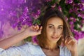 Beauty portrait young attractive woman in spring garden with pink flowers Royalty Free Stock Photo