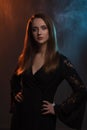 Beauty portrait of young beautiful woman wearing a black dress. Studio shot