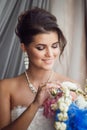 Beauty portrait of young bride holding bouquet. Perfect makeup a Royalty Free Stock Photo