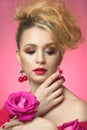 Beauty portrait of a young girl. lady in red with a rose flower Royalty Free Stock Photo