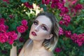 Beauty portrait of a young girl of twenty eight years old, on a pink floral background, with false eyelashes. beauty, beautiful Royalty Free Stock Photo