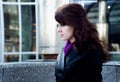 Beauty portrait of young woman with black eyeliner on urban background