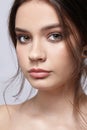 Beauty portrait of young woman on gray background