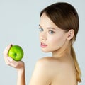 Beauty portrait of young woman holding green apple Royalty Free Stock Photo