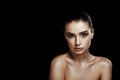 Beauty Portrait of Young Woman with Strobing Makeup Liquid on Fa