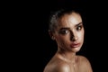 Beauty Portrait of Young Woman with Strobing Makeup Liquid on Fa