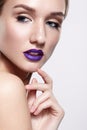 Beauty portrait of young woman with violet lips makeup