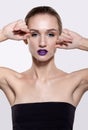 Beauty portrait of young woman with violet lips makeup