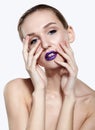 Beauty portrait of young woman with violet lips makeup