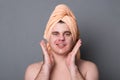 Beauty procedure and skin care. Close up portrait of calm smiling young attractive man with face mask.