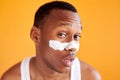 Beauty procedure and skin care, young manful man with face mask on around nose zone