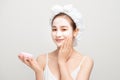 Beauty procedures skincare concept. Young woman applying facial  mud clay mask to her face in bathroom Royalty Free Stock Photo