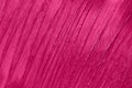 Beauty product sample closeup. Purple cosmetics smear pattern. Liquid lipstick cosmetic. Pink swatch matt backdrop.
