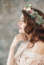 Beauty profile portrait of young woman with wreath of flowers in her hair Royalty Free Stock Photo