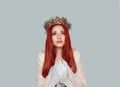 Beauty queen praying. Young woman praying looking up with hope pretty woman with crystal crown on head isolated on light gray Royalty Free Stock Photo