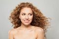 Beauty without retouching. Cheerful young woman with long healthy brown curly hair looking aside on white background. Hair care, Royalty Free Stock Photo