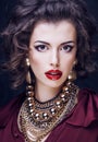 Beauty rich brunette woman with a lot of jewellery