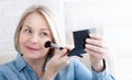 Beauty Rituals. Artistic shot of a woman immersed in the transformative process of applying makeup, accentuating her natural