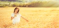 Beauty romantic girl enjoying nature in outdoors. Happy young woman in white shorts on the field of golden ripe wheat Royalty Free Stock Photo