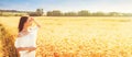 Beauty romantic girl enjoying nature in outdoors. Happy young woman in white shorts holding the ears on the field Royalty Free Stock Photo