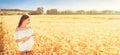 Beauty romantic girl enjoying nature in outdoors. Happy young woman in white shorts holding the ears on the field Royalty Free Stock Photo