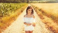 Beauty romantic girl enjoying nature in outdoors. Happy young woman in white shorts holding the ears of golden wheat Royalty Free Stock Photo