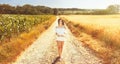 Beauty romantic girl enjoying nature in outdoors. Happy young woman in white shorts holding the ears on the road Royalty Free Stock Photo