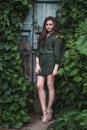 Beauty Romantic Girl Outdoor. Beautiful Teenage Model Dressed in Fashionable Green Dress Posing Outdoors in park Royalty Free Stock Photo