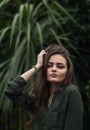 Beauty Romantic Girl Outdoor. Beautiful Teenage Model Dressed in Fashionable Green Dress Posing Outdoors in park. Toned in warm co Royalty Free Stock Photo