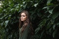 Beauty romantic girl outdoor. Beautiful teenage model dressed in fashionable green dress posing outdoors in park. Toned in warm co Royalty Free Stock Photo