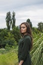 Beauty Romantic Girl Outdoor. Beautiful Teenage Model Dressed in Fashionable Green Dress Posing Outdoors in park. Toned in warm co Royalty Free Stock Photo