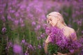 Beauty romantic girl outdoors. Beautiful teenage model with pink hair girl on the field of fireweed in sunrise Royalty Free Stock Photo