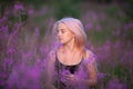 Beauty romantic girl outdoors. Beautiful teenage model with pink hair girl on the field of fireweed in sunrise Royalty Free Stock Photo