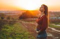 Beauty Romantic is pregnant Girl Outdoors enjoying nature holding her belly Beautiful autumn model in nature in the rays of sunset Royalty Free Stock Photo