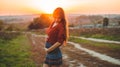 Beauty Romantic is pregnant Girl Outdoors enjoying nature holding her belly Beautiful autumn model in nature in the rays of sunset Royalty Free Stock Photo