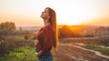 Beauty Romantic is pregnant Girl Outdoors enjoying nature holding her belly Beautiful autumn model in nature in the rays of sunset Royalty Free Stock Photo