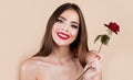 Beauty romantic smiling woman with red rose flowers. Beautiful luxury makeup. Valentines Day design. Portrait of fashion Royalty Free Stock Photo