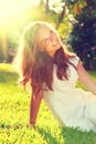 Beauty Romantic teenage Girl sitting on green grass