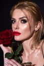 Beauty romantic woman with red rose flowers. Beautiful luxury makeup. Valentines Day design. Portrait of fashion model Royalty Free Stock Photo