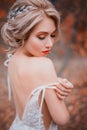 Beauty romantic young woman in white dress with open back gentle posing. Royalty Free Stock Photo